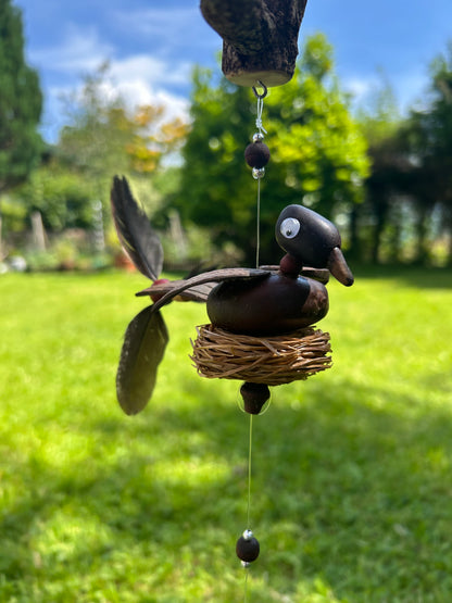 Windspiel Ente auf Baumstamm